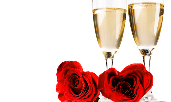Two heart shaped red roses and champagne isolated on white background, Valentines day
