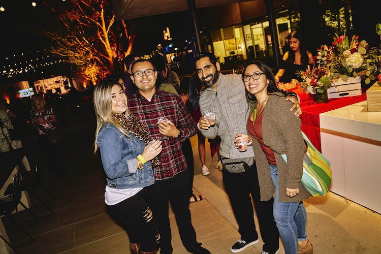 Group of friends holding drinks at The Taste Costa Mesa.