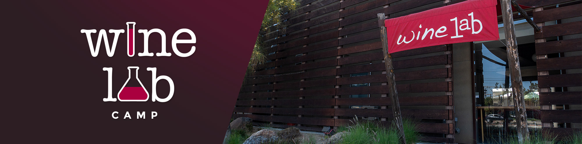 A modern building with a red wine lab banner hangs outside. The wine lab camp logo, featuring a wine glass in a beaker, is shown on a maroon background beside the building.