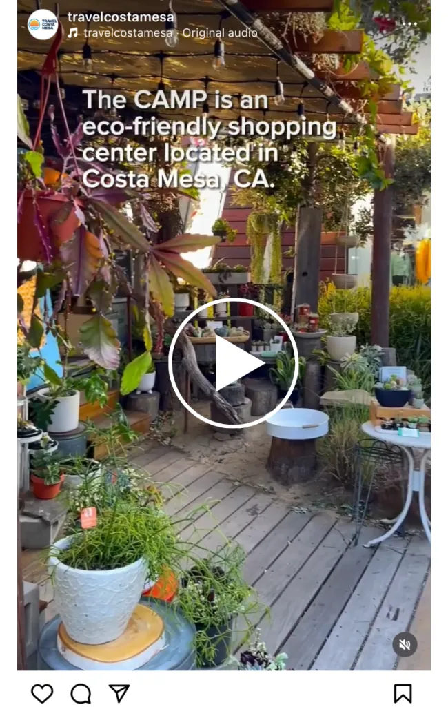 A lush outdoor shopping area with potted plants, wooden walkways, and garden decor. Text on the image reads, The CAMP is an eco-friendly shopping center located in Costa Mesa, CA.