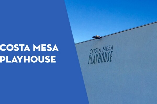 Exterior of Costa Mesa Playhouse building featuring colorful horizontal accents and address number 661 on the corner, set against a clear blue sky. The Costa Mesa Playhouse name appears on a blue overlay to the left.
