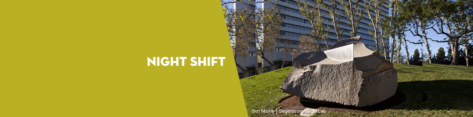 Large stone sculpture on a grassy hill in Costa Mesa, with a tall building and trees in the background. The left half of the image is solid yellow-green with the text “NIGHT SHIFT.”.