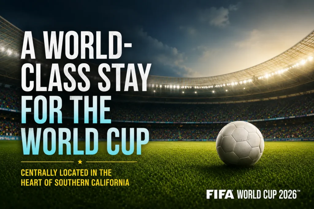 A soccer ball rests on a green field inside a brightly lit stadium, with text highlighting world-class accommodations for the FIFA World Cup 2026 Los Angeles in Southern California.
