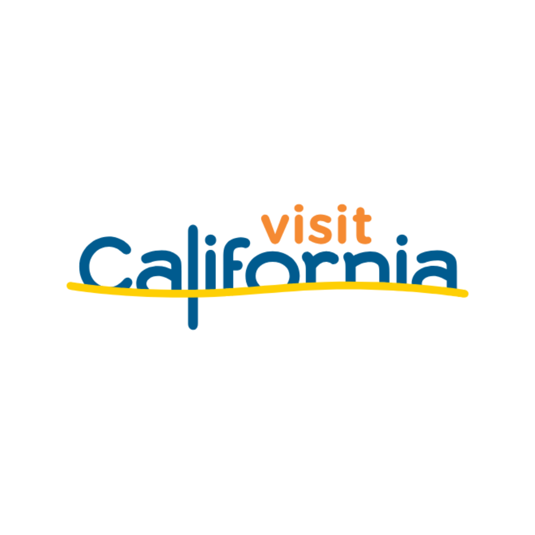 Logo with the words visit California in blue and orange text. A yellow curved line runs horizontally beneath California, giving a sense of movement. The background is white.