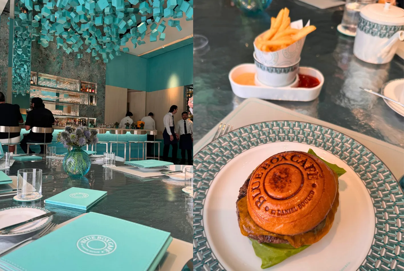 A chic café with turquoise decor, neatly set tables, and staff behind the counter—reminiscent of the trendy ambiance found at Vox Kitchen Costa Mesa. Close-up of a burger with Blue Box Café stamped on the bun, fries in a cup, and tea set on a stylish patterned plate.