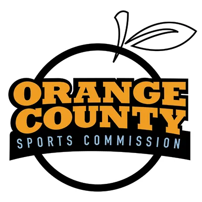Logo with an orange outline and leaf. Text inside reads Orange County in bold orange letters and Sports Commission in white on a black banner.
